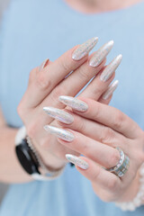 beautiful female hands with long nails light white manicure
