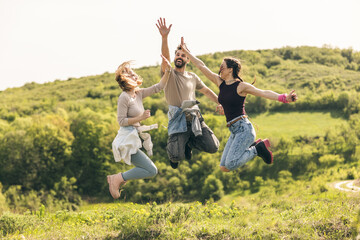 Happy Friends Jumping In Nature