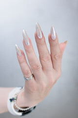 beautiful female hands with long nails light white manicure