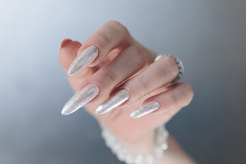 beautiful female hands with long nails light white manicure
