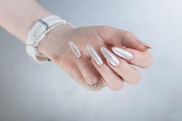 beautiful female hands with long nails light white manicure