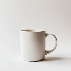 Simple off-white ceramic mug centered on an off-white surface. Clean design and versatile drinkware for coffee, tea, or other hot beverages.
