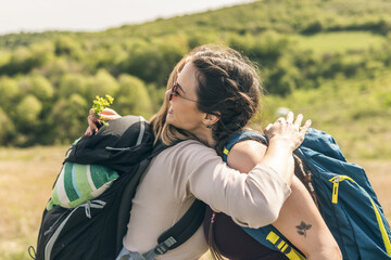 Friends Hugging While Hiking