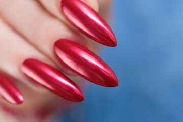 Female hands with long nails and red nail polish