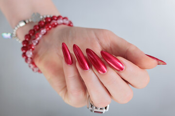 Female hands with long nails and red nail polish
