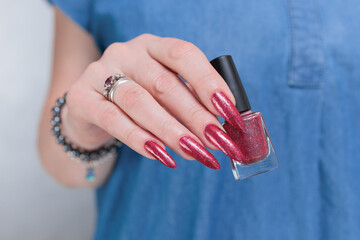 Female hands with long nails and red nail polish