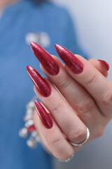 Female hands with long nails and red nail polish