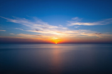 Fototapeta premium beautiful sunset over the ocean with clouds in the sky 2