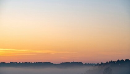 Obraz premium Serene sunrise over misty landscape nature scene tranquil environment outdoor viewpoint captivating dawn colors
