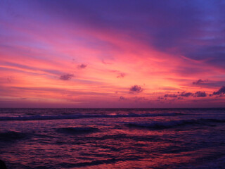 Sunset, vibrant colorful sunset over ocean horizon with dramatic sky and peaceful sea waves, perfect for travel, summer, or tropical backgrounds.

