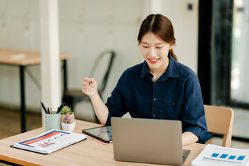 Young Asian woman doing financial accounting and taxes for a company Organizing account analysis reports Investment information Financial and tax system concepts