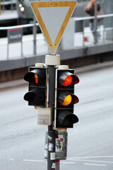 Traffic light with yellow signal and yield sign – urban traffic concept