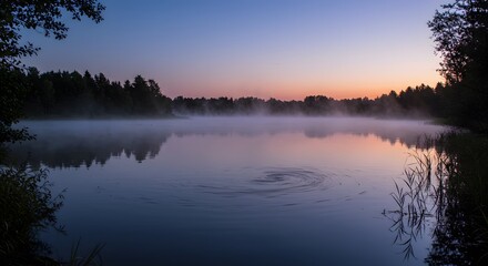 Obraz premium Peaceful Lake Reflecting Sky with Mist in Early Morning