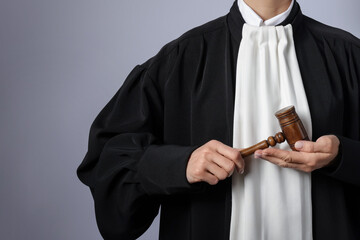 Judge with mallet on light background, closeup