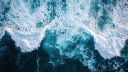 An aerial view of ocean waves crashing, showcasing the vibrant blues and foamy white caps, capturing the beauty and power of nature.
