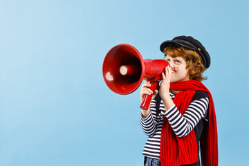 Cute boy in mime costume shouting in megaphone on light blue background, space for text. Surprise...