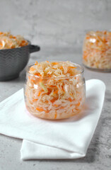 Fermented cabbage in a transparent bowl.
