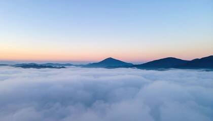 Fototapeta premium Majestic sunrise over mountain peaks foggy landscape aerial view tranquil nature scene