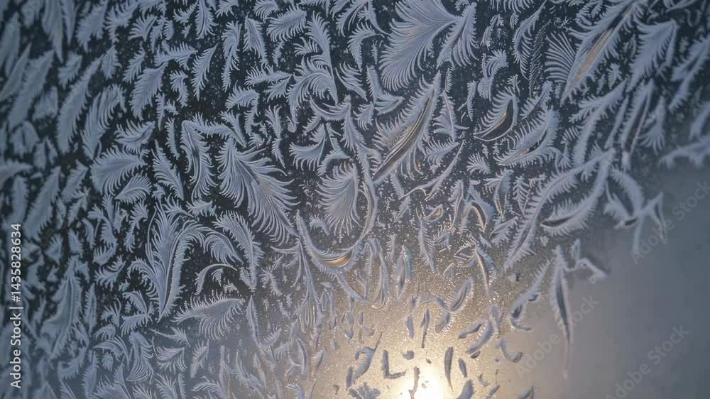 Poster frost patterns on glass with sun rays creating a beautiful winter scene