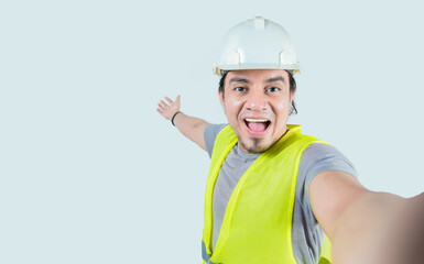 Selfie of smiling engineer inviting you isolated. Self portrait of happy construction engineer...