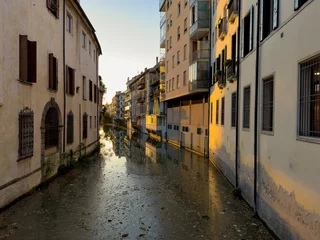 Fotobehang Naviglio Interno water canal in Padova, Italy at sunset, full of trash © mino21