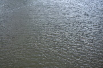 Water surface with small ripples in drizzle weather