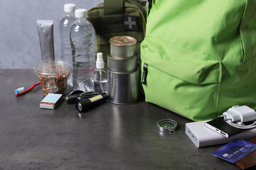 Survival kit. Different emergency supplies on grey table