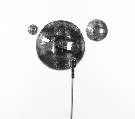 silver disco balls and microphone isolated on white background
