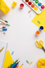 Art and school vertical supplies neatly arranged on a white surface, including pencils and paints