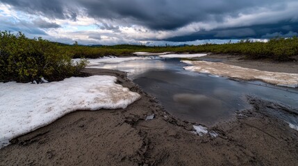 Fototapeta premium Alaskan Tundra Meltwater Puddle Under Storm Clouds