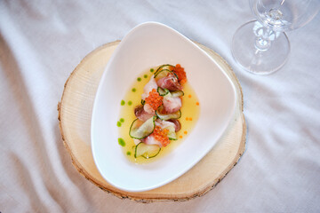 salad with fish and red caviar on a plate