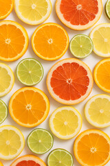 Obraz premium Colorful citrus fruit slices background orange lemon lime grapefruit healthy eating summer refreshment juice 