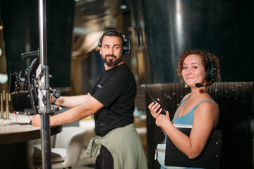 Director at work on the set. The director works with a group or with a playback while filming a...