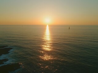 a serene sunset over the ocean, with the sun reflecting off the water's surface.