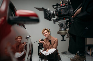 Director at work on the set. Shooting shift, equipment and group. Modern photography technique.