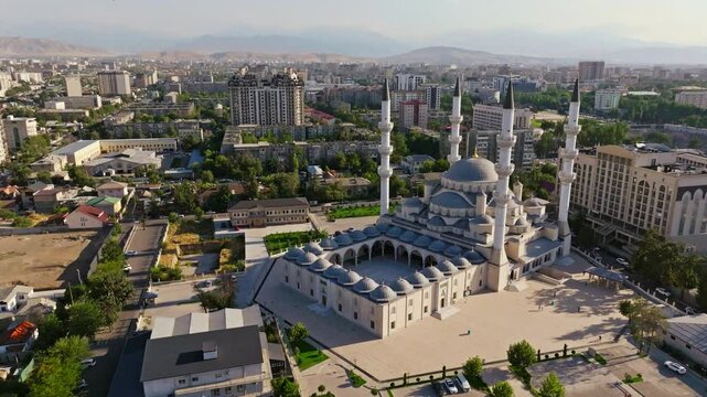 Aerial footage of Bishkek Central Mosque, also known as Turkish Mosque, in Bishkek, Kyrgyzstan during summer 2024. Features Islamic architecture, minarets, and surrounding urban area. Ideal for