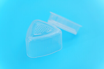 Plastic Triangular Onigiri Molds on a blue background
