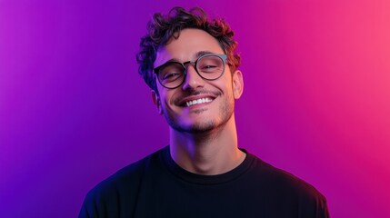 Fototapeta premium Smiling young man in glasses poses against a colorful gradient background with purple and pink hues