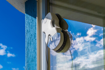 Robot window cleaner washes glass with round rags, robotic service, modern technologies