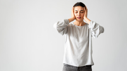 Regretful woman holds her head with her hands