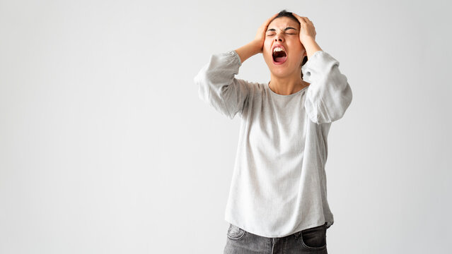 Angry young woman screaming
