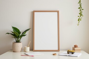 Minimalist Workspace with Blank Frame, Plant, Notebooks, and Stationery on Elegant Desk