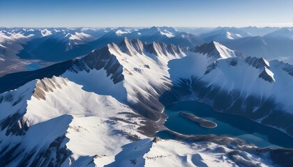 Stunning aerial view of snow-capped mountain range with a serene turquoise lake.
