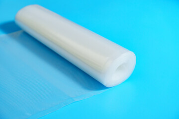 Roll film for a product vacuum sealer machine on a blue background.