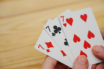 A winning combination of playing cards on a wooden background. card gambling.