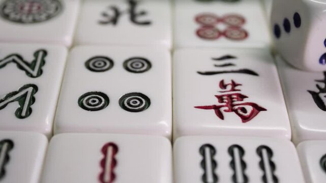 Close-up of Mahjong tile set,Mahjong is a tile-based game from 19th-century China that has gained global popularity since the early 20th century,4k,slow-motion,truck camera movements