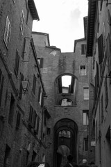 Siena old town street in black and white. Tuscany, Italy.