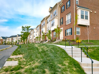 residential complex of three-story modern brick homes in Leesburg, Virginia.