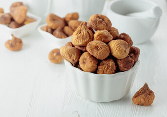 Organic dried figs on a white table.