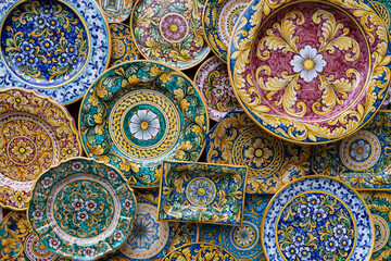 Colorful plates of various forms and sizes with traditional sicilian floral pattern, Sicily, Italy